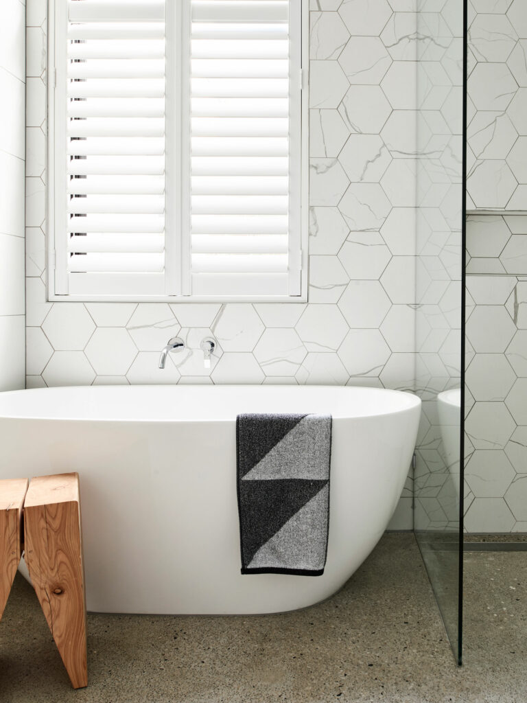 Maike Design freestanding bath, concrete floor and marble tiles