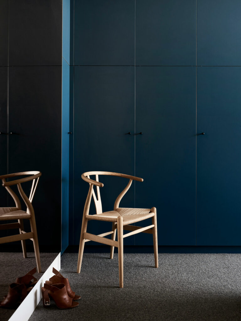 Maike Design moody dark teal bedroom cabinets and bronze mirror
