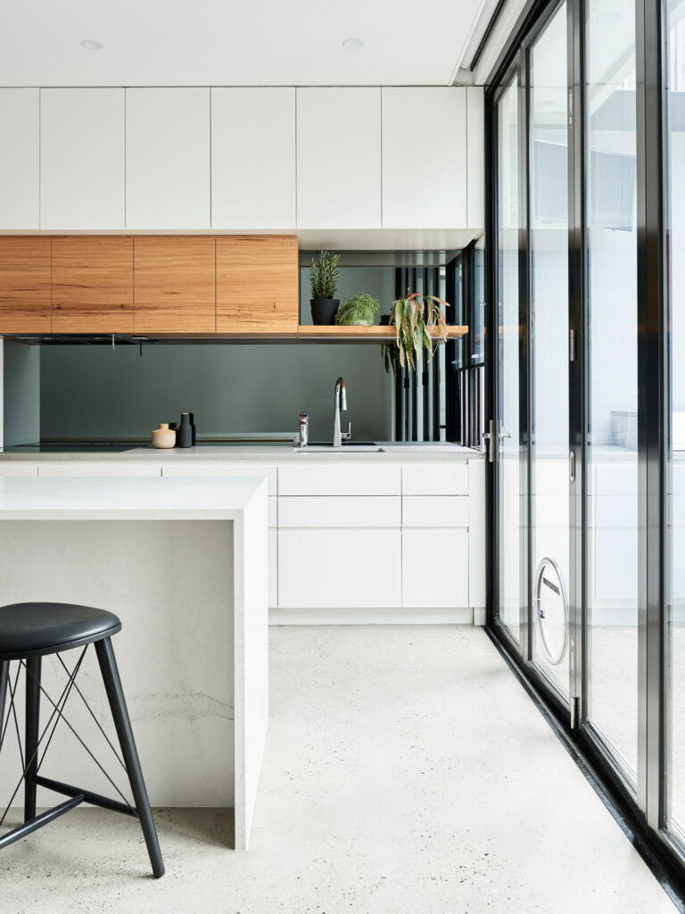 Maike Design white kitchen with concrete floor and white marble bench