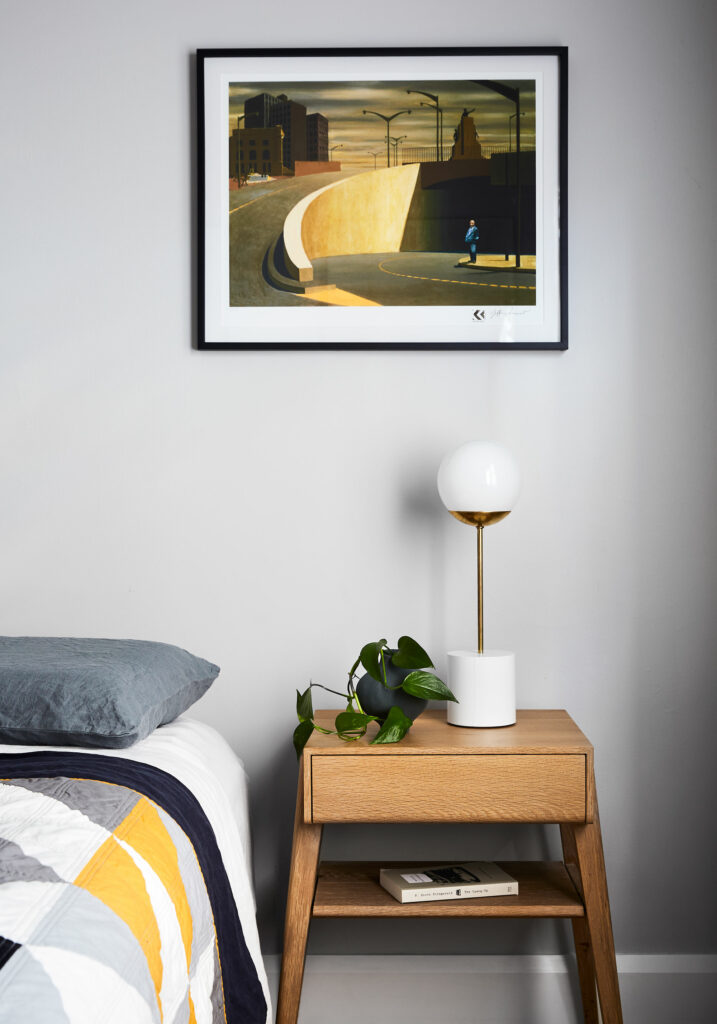 Maike Design bedroom, hand made quilt, bedside table, lamp and grey walls