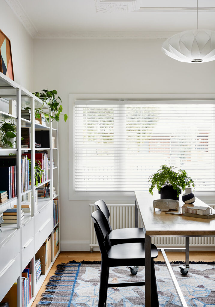 Maike Design creative workspace with textured rug, bookshelves and drawing board