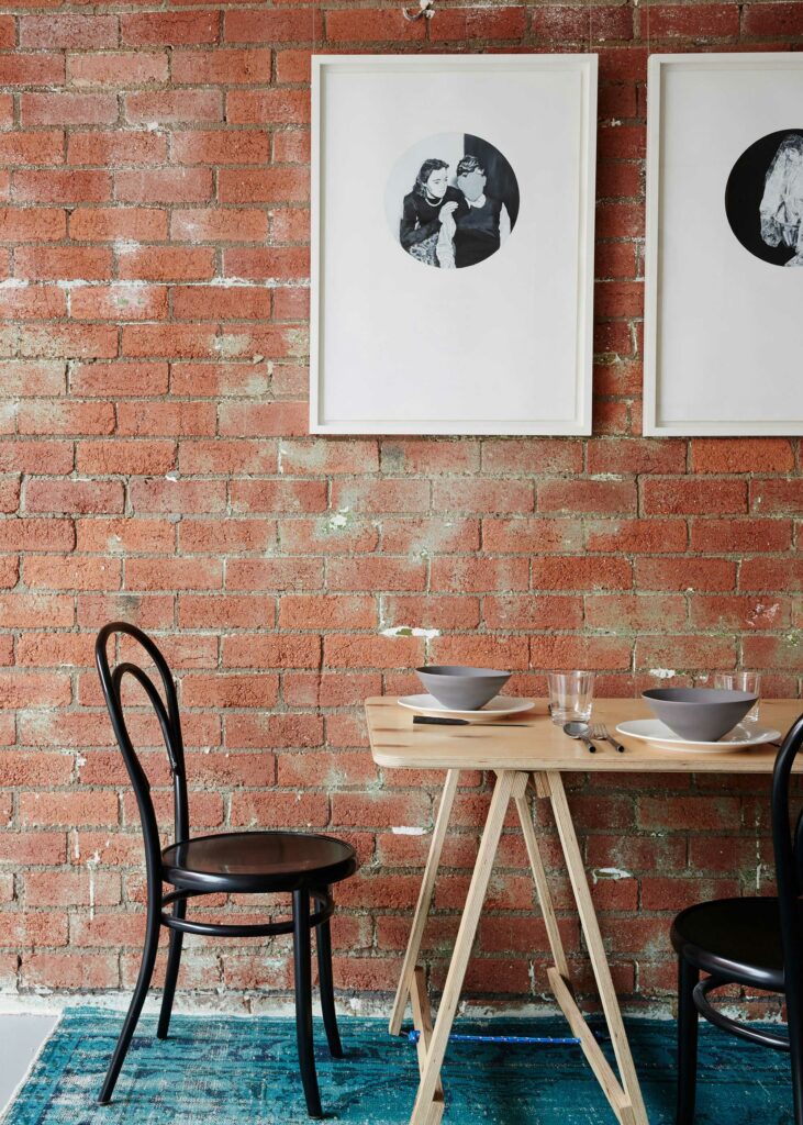 Maike Design Creative workspace, warehouse conversion. Red brick wall and dining table