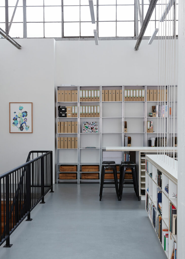Maike Design Creative workspace, warehouse conversion. Steel book shelves and office space