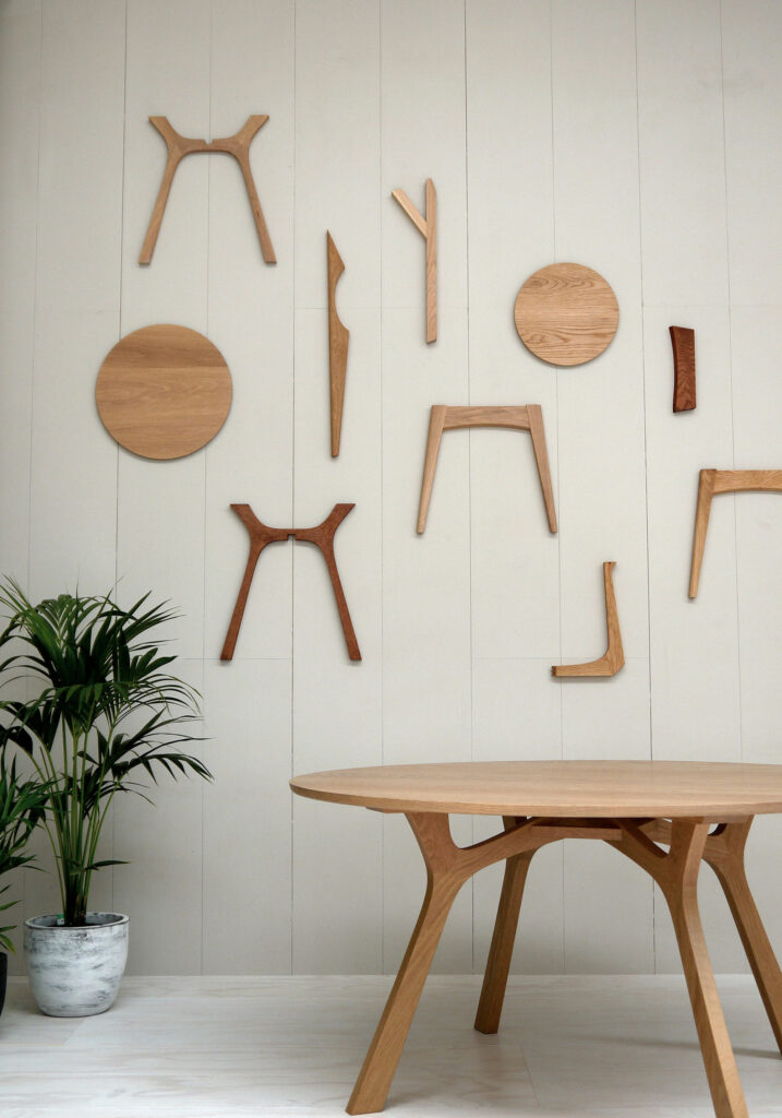 Maike-Design_TIDE-showroom-11-1 Maike Design furniture showroom with timber walls. Timber dining table and deconstructed timber chair on the wall.