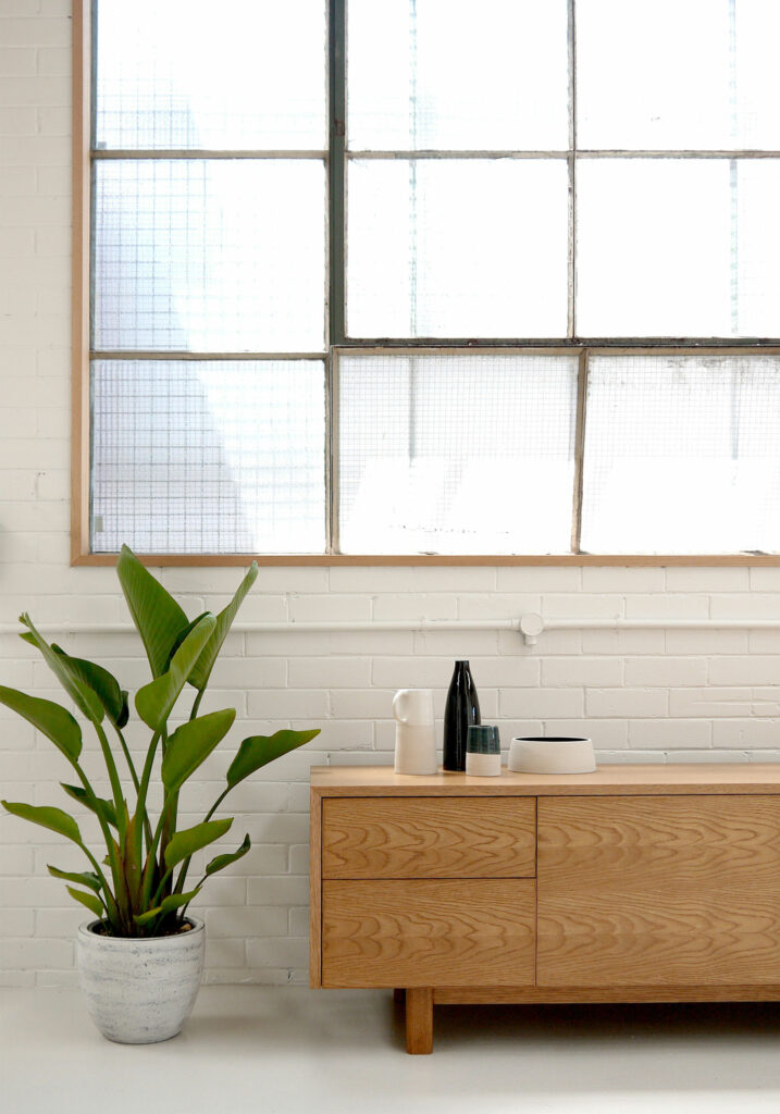 Maike-Design_TIDE-showroom-12 Maike Design furniture showroom with painted brick walls and industrial steel windows. Timber dresser and handmade ceramics