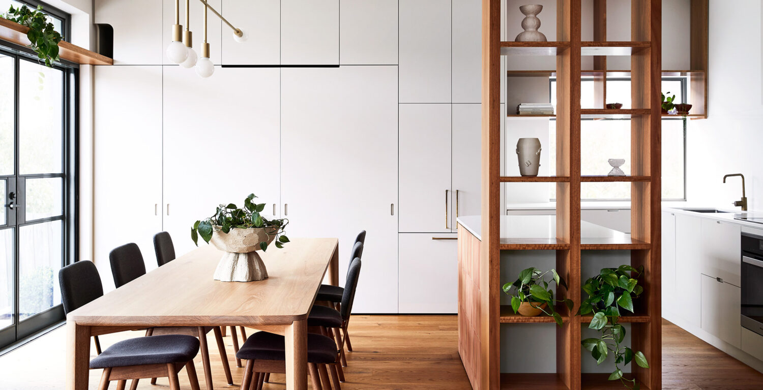 Maike Design kitchen and dining room. Open timber shelves, indoor plants, brass pendant light, teracotta tiles, timber floors.