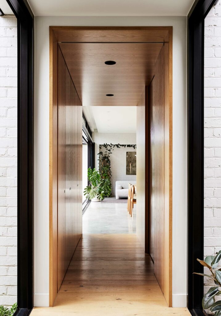 Maike Design garden connection. Glass hallway link. Timber wall panels through to dining room and lounge