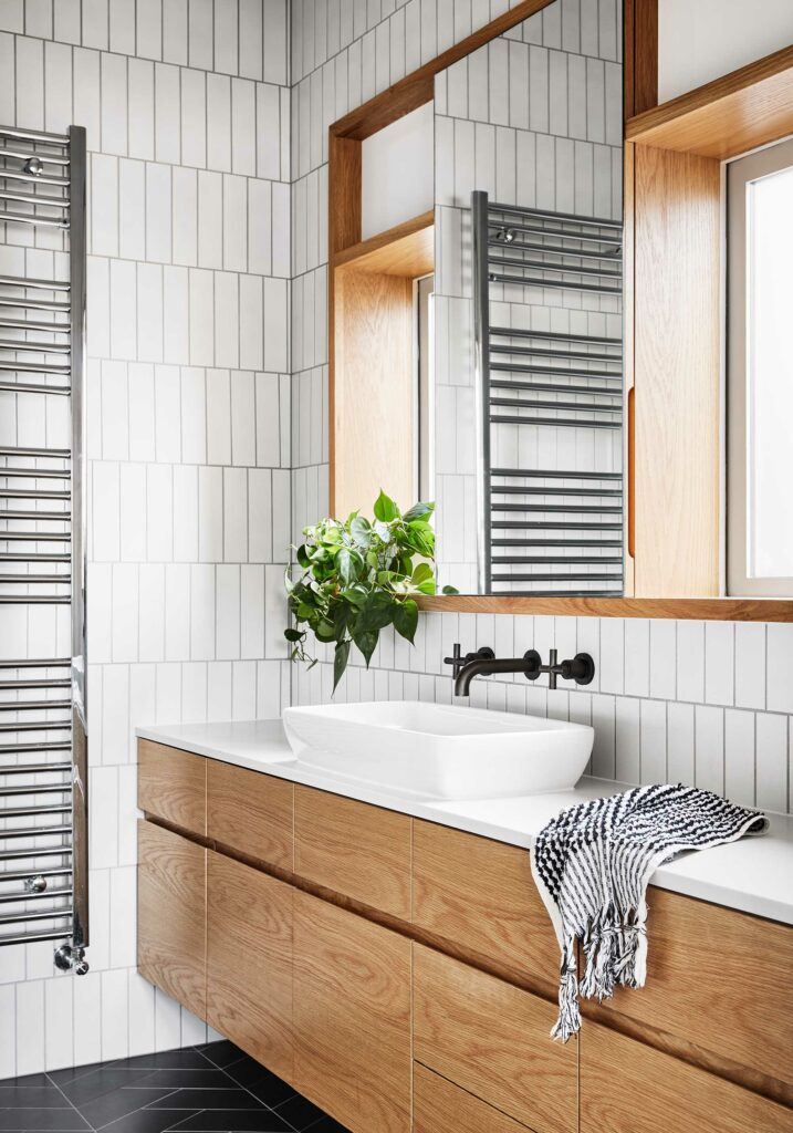 Maike Design bathroom. White and black tiles. Timber joinery and charcoal tapware