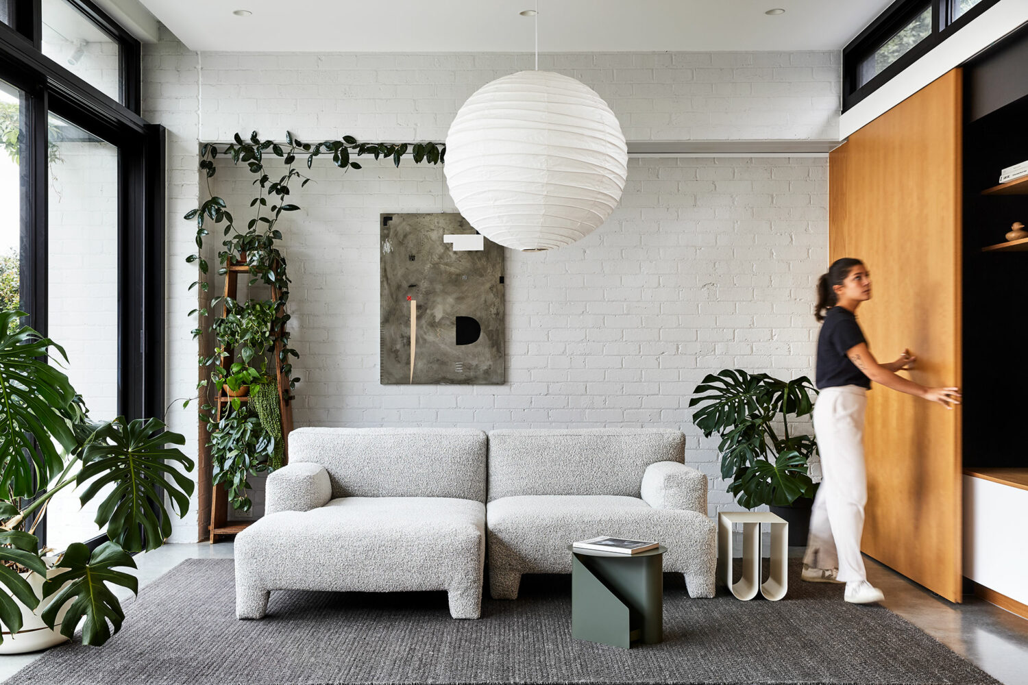 Maike Design lounge room. White painted bricks, indoor plants and timber joinery