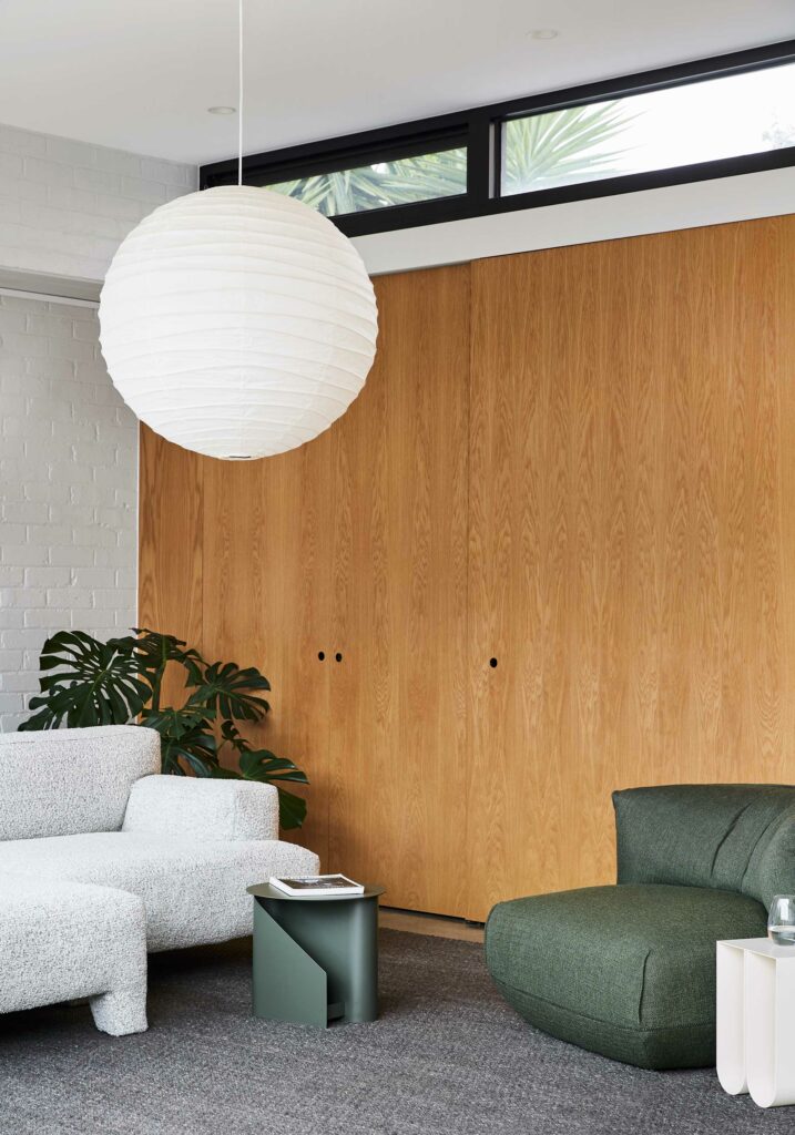 Maike Design lounge room. White painted bricks, indoor plants and timber joinery