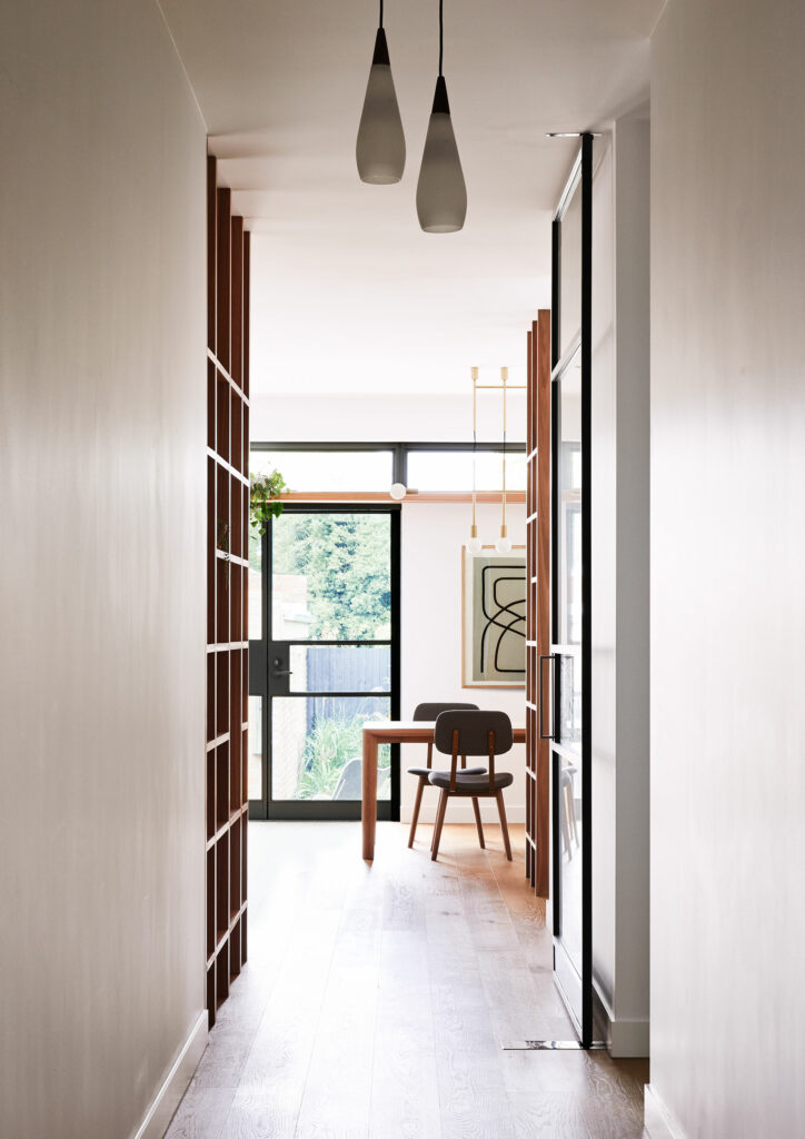 Maike Design lounge room. Vintage lights, hallway, timber floors timber joinery