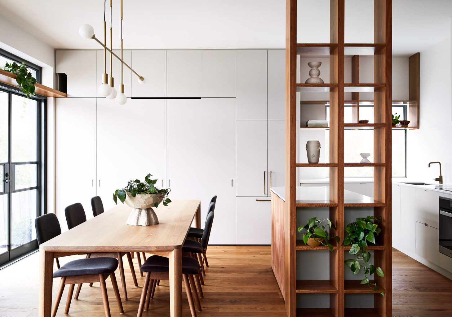 Maike-Design_Meow-House-13 Maike Design kitchen and dining room. Open timber shelves, indoor plants, brass pendant light, teracotta tiles, timber floors.