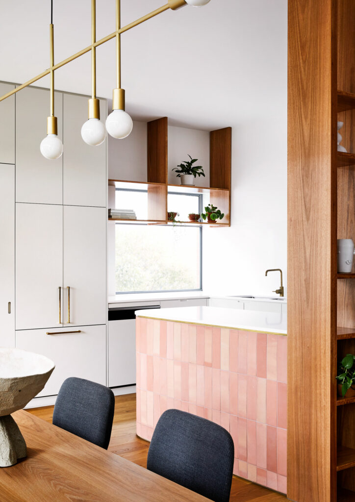 Maike Design kitchen and dining room. Open timber shelves, indoor plants, brass pendant light, teracotta tiles, timber floors.