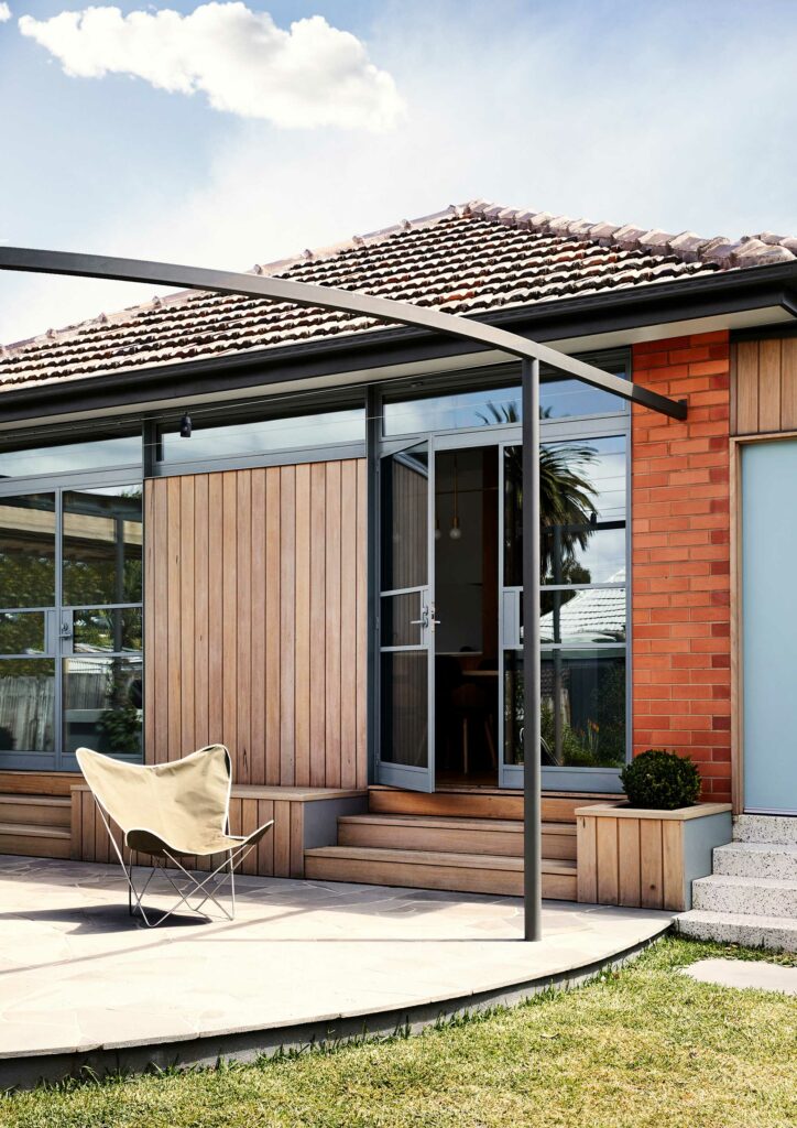 Maike Design alfresco area. Timber cladding and ornage bricks. Steel framed windows, crazy paving