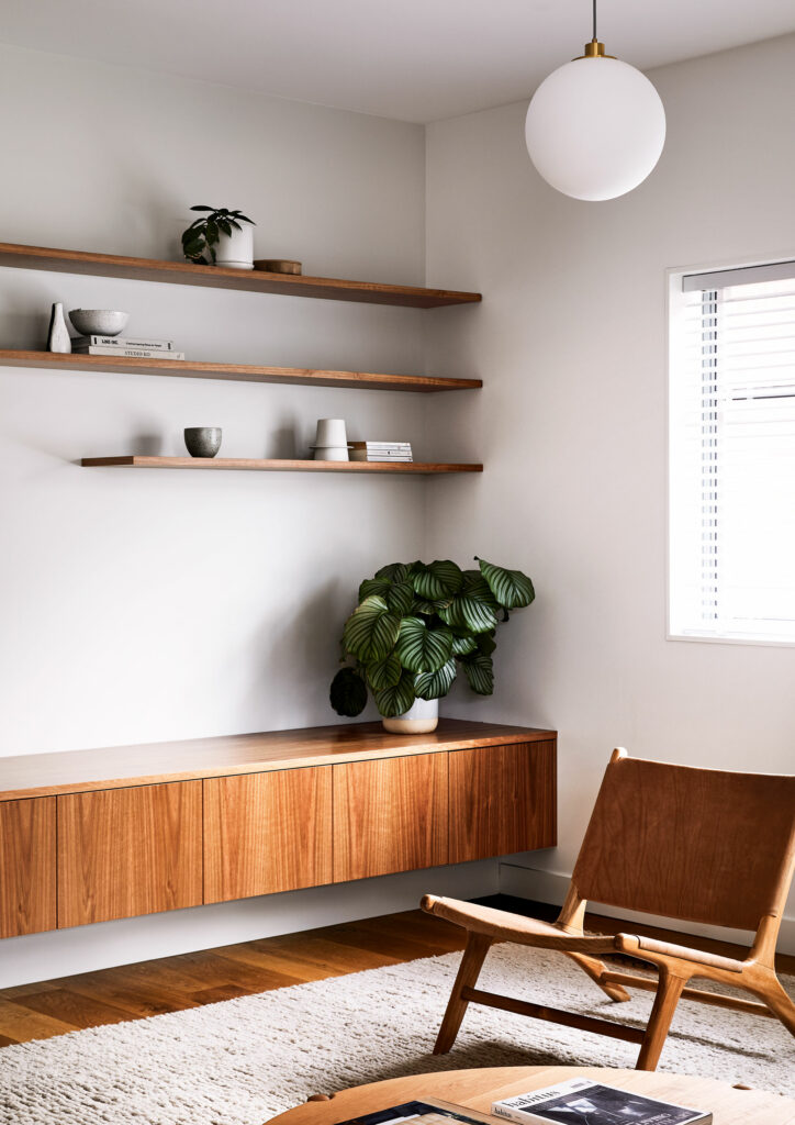 Maike Design lounge room. pendant light, indoor plants and timber joinery. Vintage leather chair